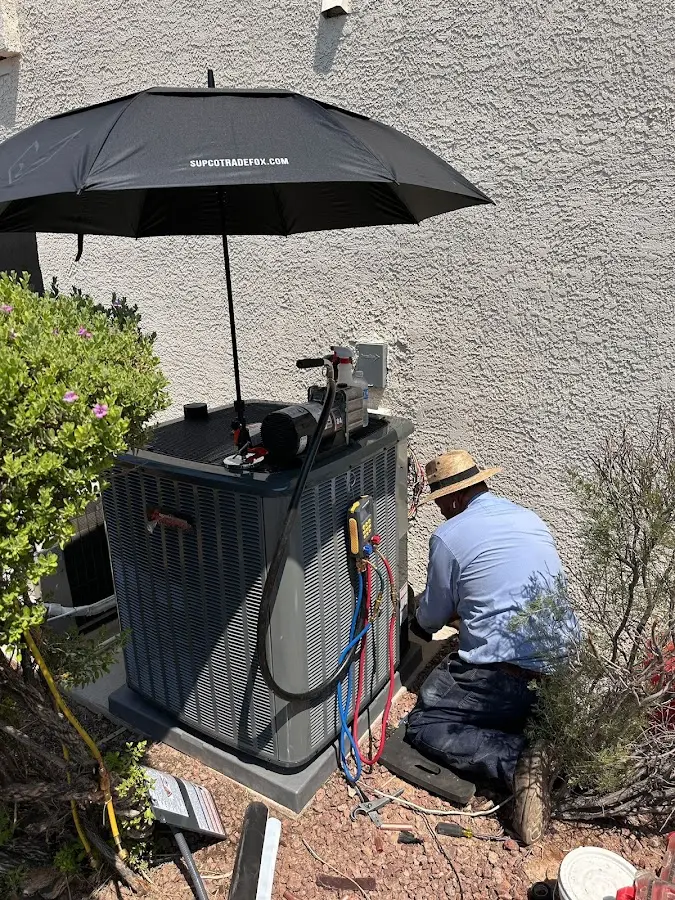 HVAC technician performing outdoor AC maintenance in East Pikeland