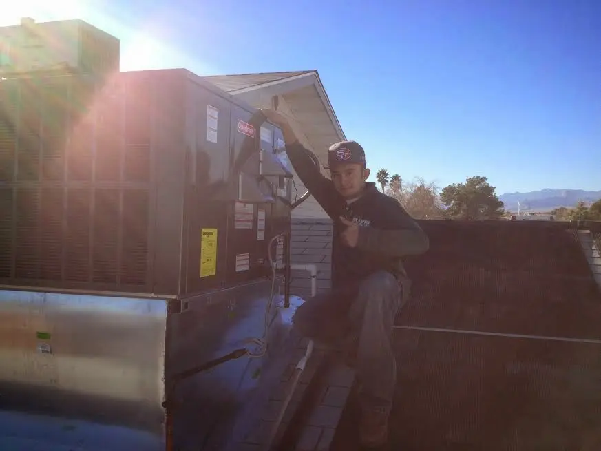 HVAC technician performing Air Duct Repair on a rooftop unit in East Pikeland
